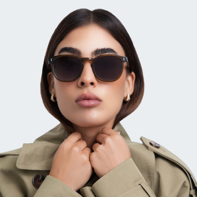 Another angle of a woman in a trench coat wearing Eldridge Sunglasses Moss with Grey Flat Gradient