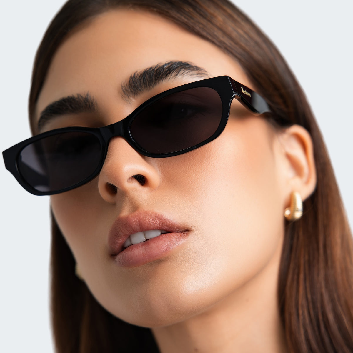 Woman wearing Encinitas Sunglasses in Black with Grey lenses, front view, Close up of a woman