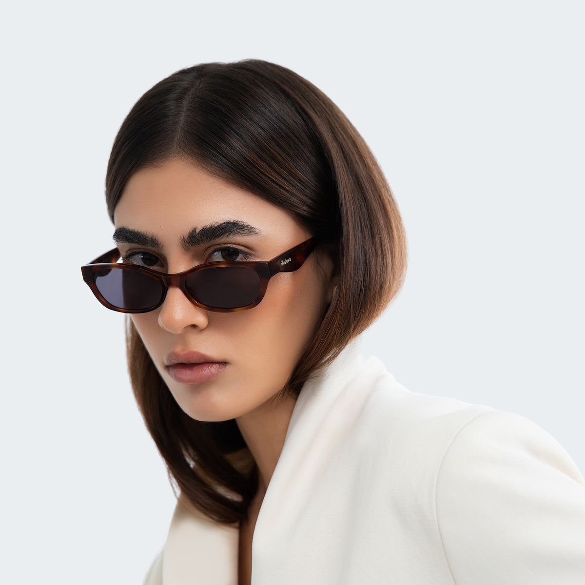 Woman wearing Encinitas Sunglasses in Havana with Grey lenses, front view, Woman in a white blouse