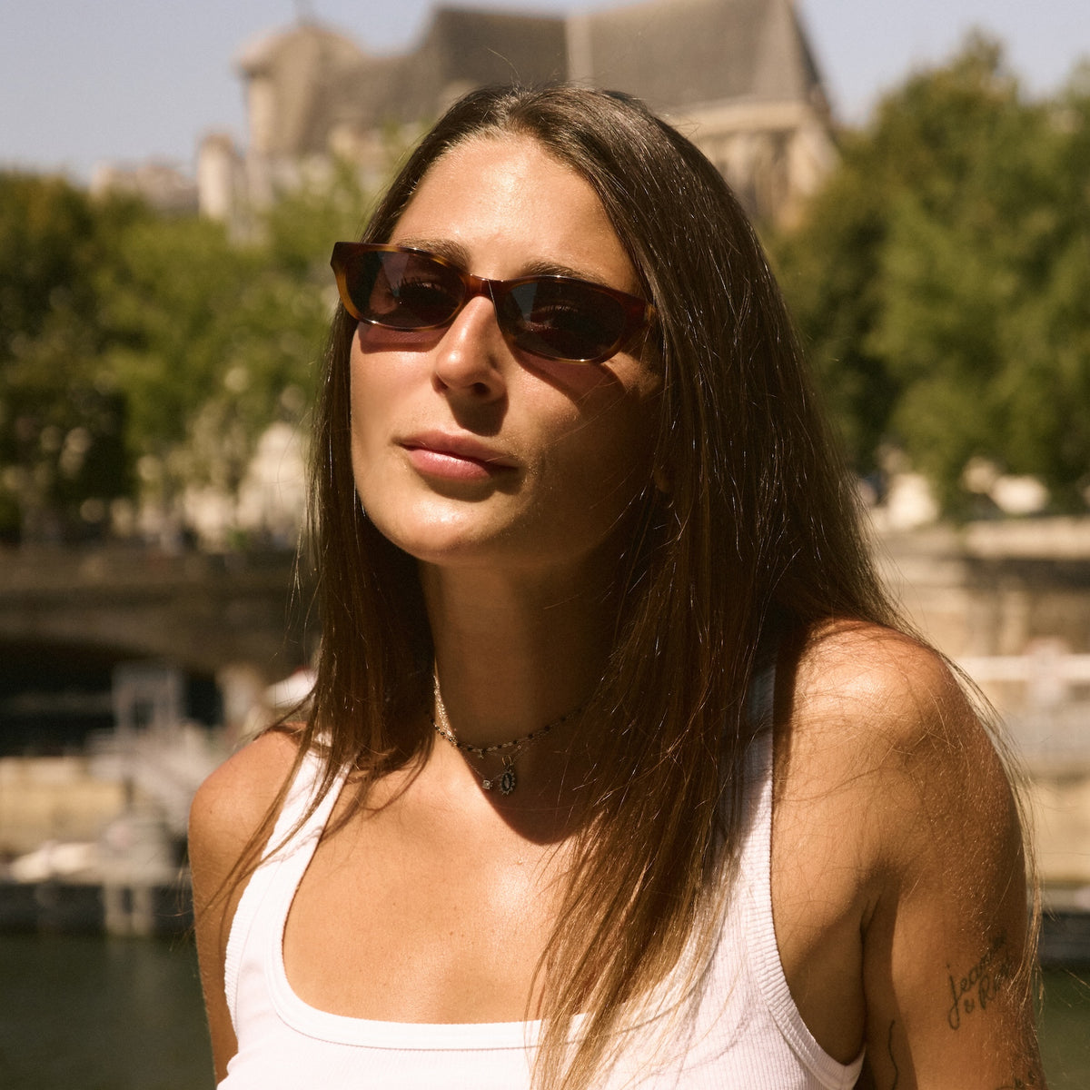 Woman wearing Encinitas Sunglasses in Havana with Grey lenses, Woman in Paris near trees