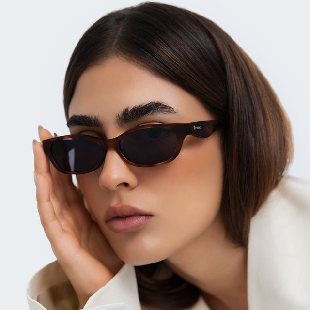 Close up of a woman in a studio wearing Encinitas Sunglasses Havana with Grey