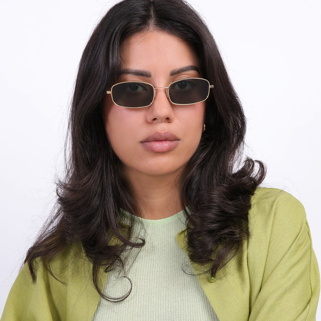 Brunette model wearing Flushing Sunglasses Gold with Olive Flat