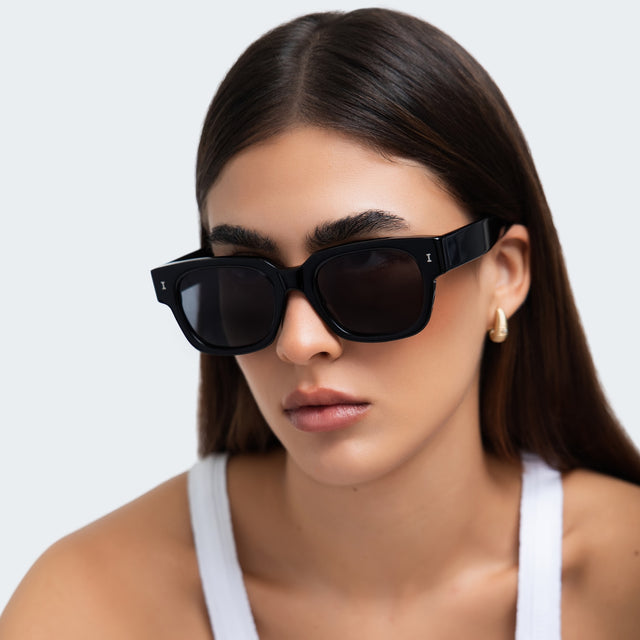 Woman in a white tank top wearing Francesco Sunglasses Black with Grey