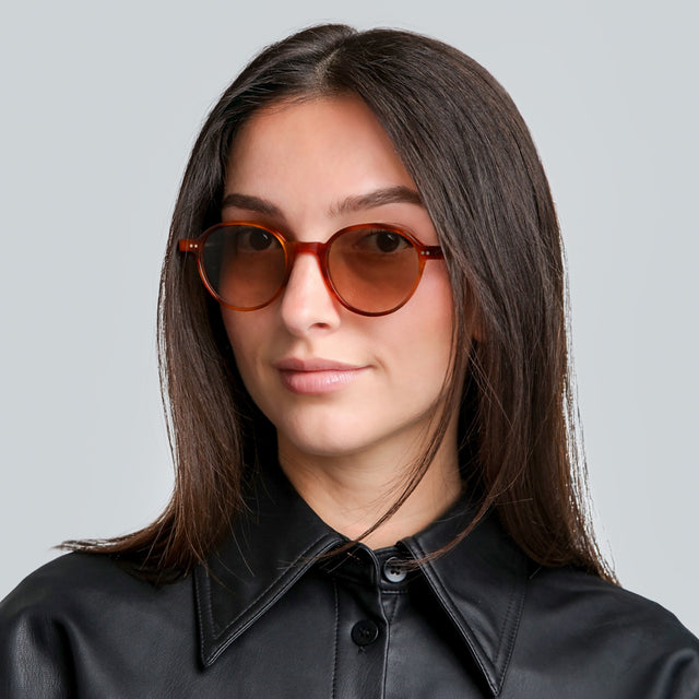 Woman in a leather blouse wearing Frankfurt Sunglasses Red Havana with Taupe Gradient