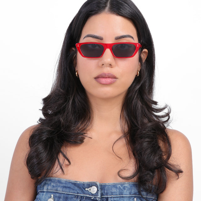 Brunette model with loose curls wearing Hogan Sunglasses Red