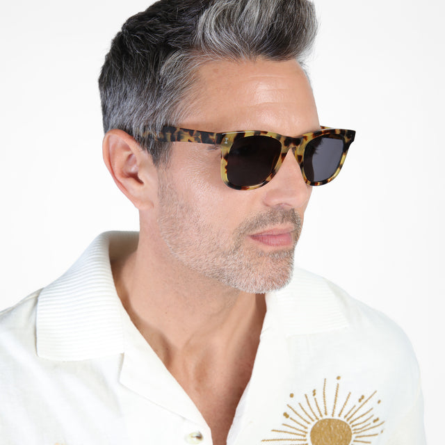 Model with salt and pepper hair and beard looking left wearing James Sunglasses Tortoise with Grey