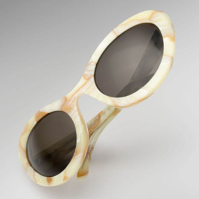Kim Shui Sunglasses tilted at a diagonal  Savannah Cream Marble with Grey 