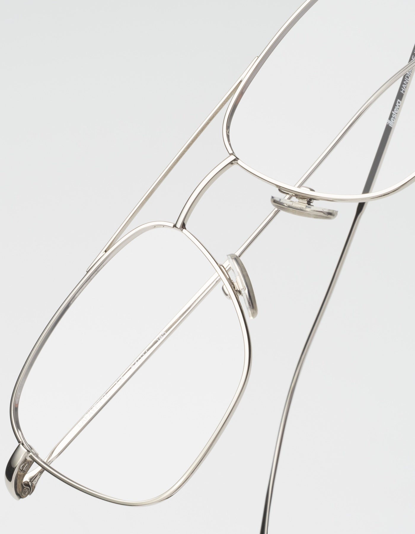 Close up of Lafayette eyeglasses in silver displayed on a light gray background