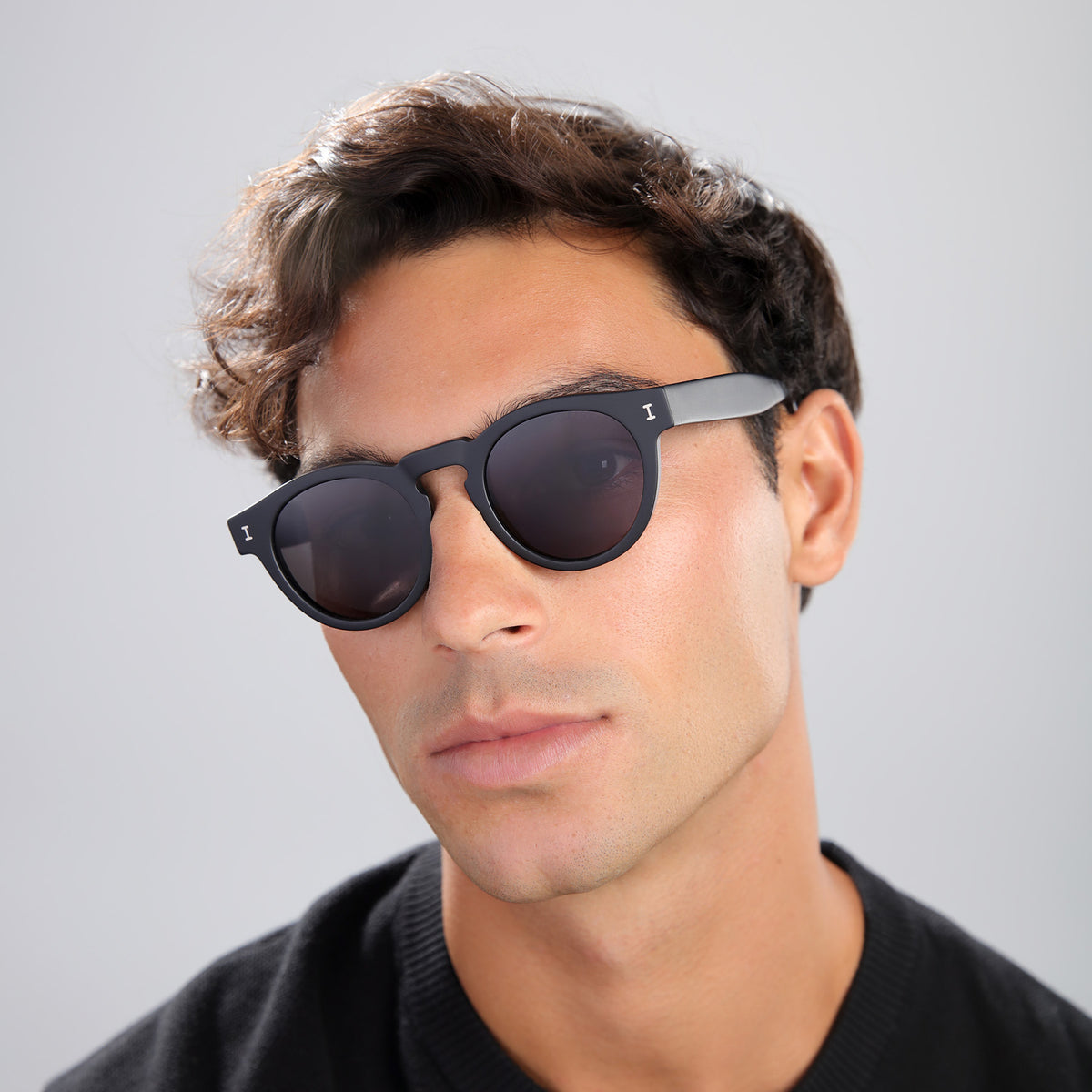 Man wearing Leonard Polarized Sunglasses in Matte Black with Grey Polarized lenses, front view, Man in a black tee