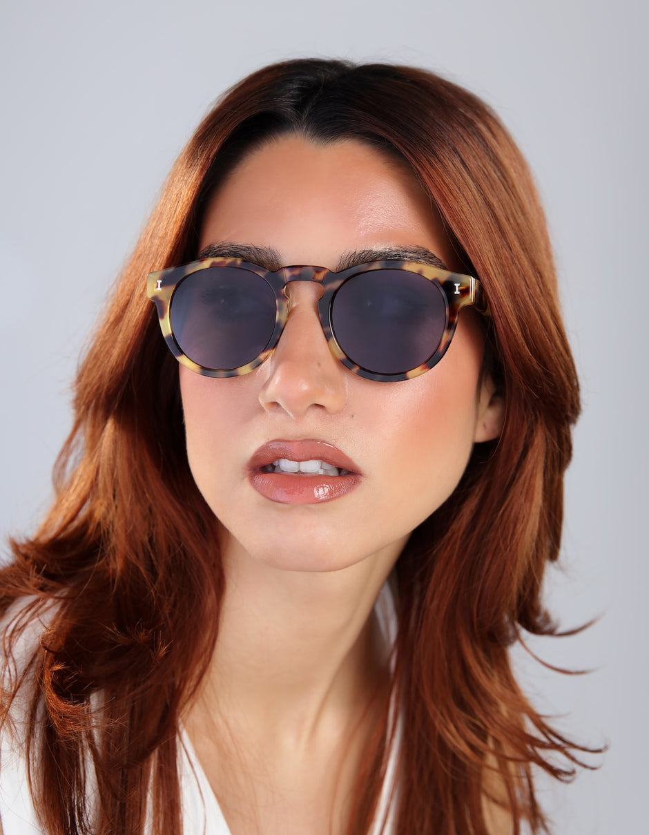 Woman with red hair wearing Leonard Sunglasses in Tortoise with Grey lenses