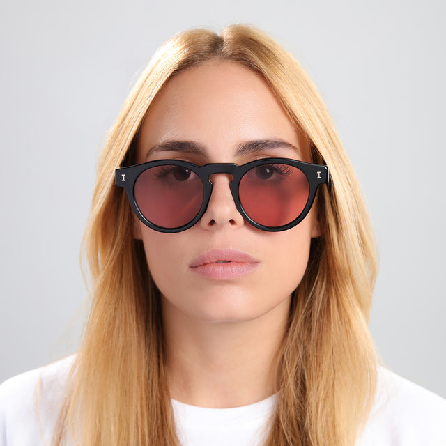 Blonde woman in a white tee wearing Leonard Sunglasses Black with Bordeaux See Through