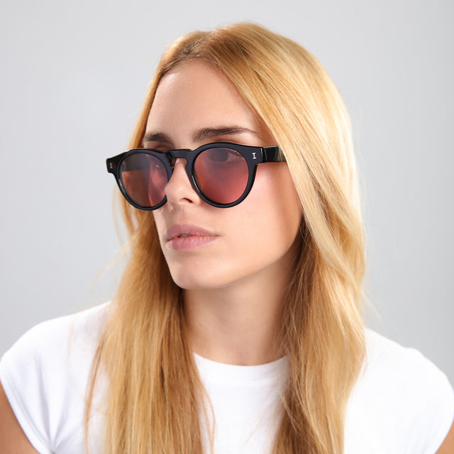 Another angle of blonde woman in a white tee wearing Leonard Sunglasses Black with Bordeaux See Through