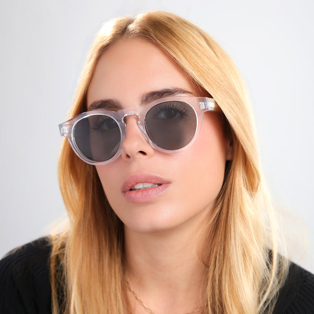 Blond woman in a black tee wearing Leonard Sunglasses Clear with Olive
