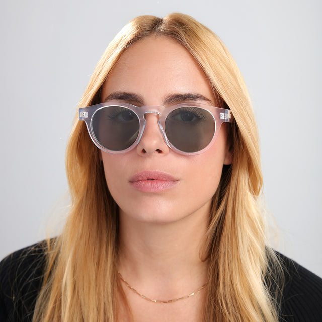 Another angle of woman in a black tee wearing Leonard Sunglasses Clear with Olive