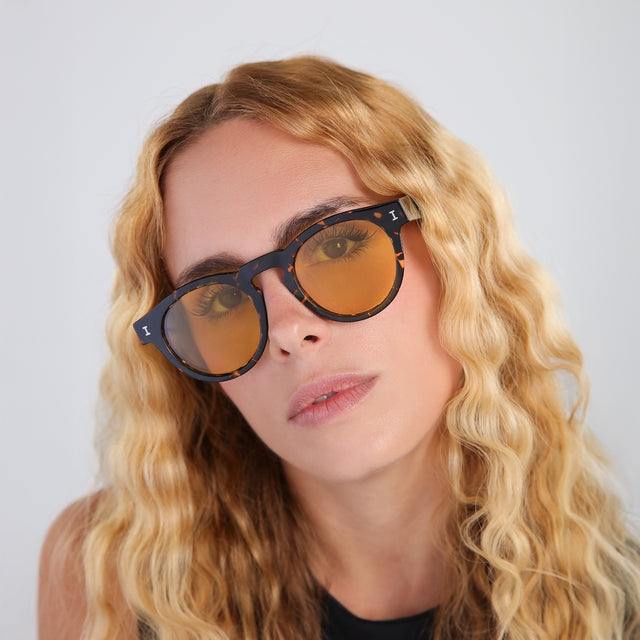 Another angle of blond woman with wavy hair wearing Leonard Sunglasses Flame with Honey See Through