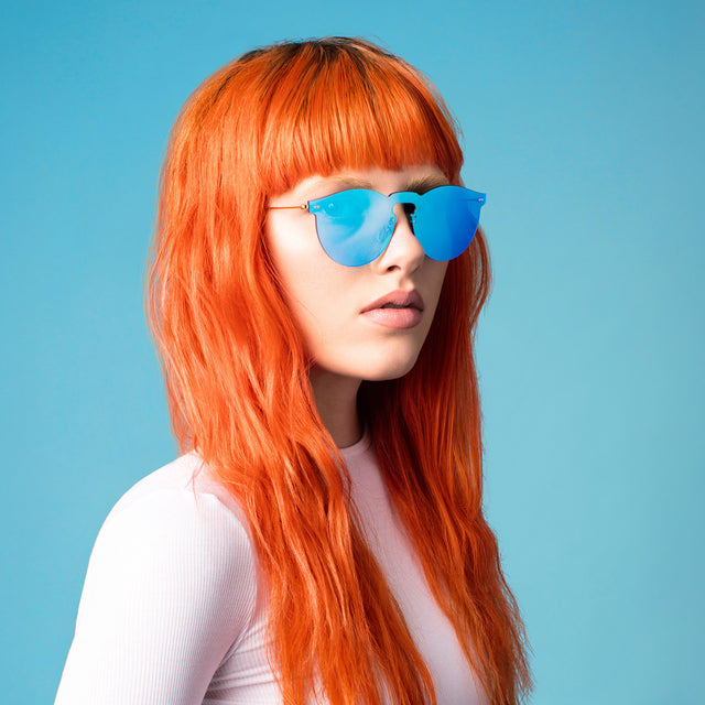 Model in Bright red hair wearing wearing Leonard Mask Sunglasses Light Blue with Light Blue