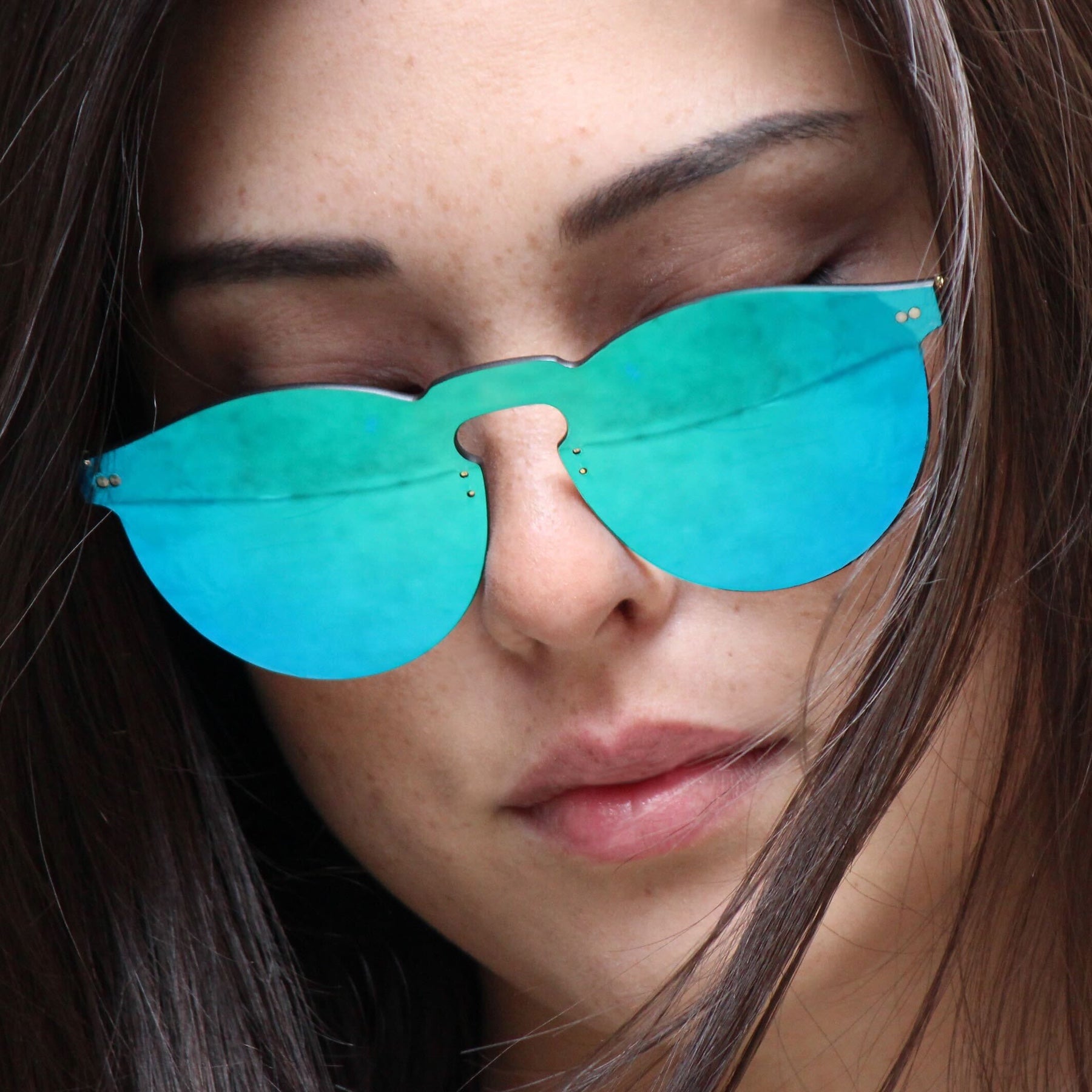 Brunette model with curtain bangs wearing Leonard Mask in Light Blue