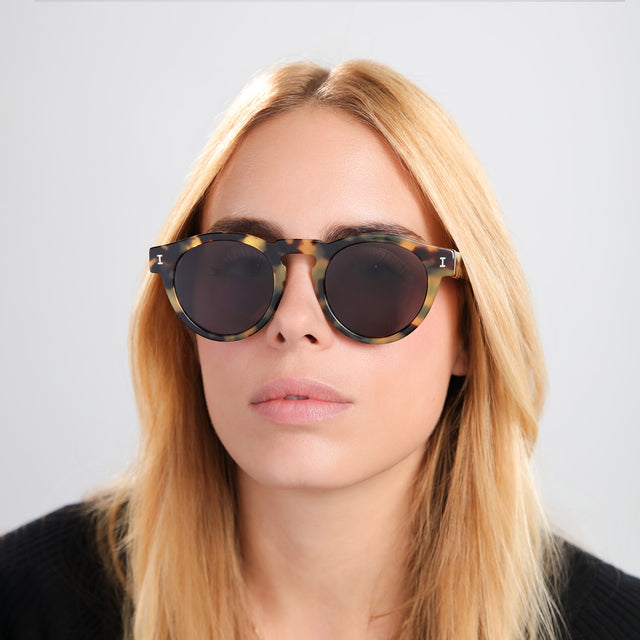 Another angle of blond woman in a black tee wearing Leonard Sunglasses Tortoise with Grey