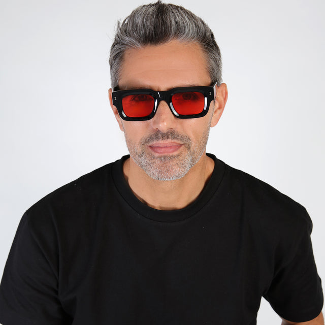 Model with salt and pepper hair and beard wearing Lewis Sunglasses Black with Red Flat See Through