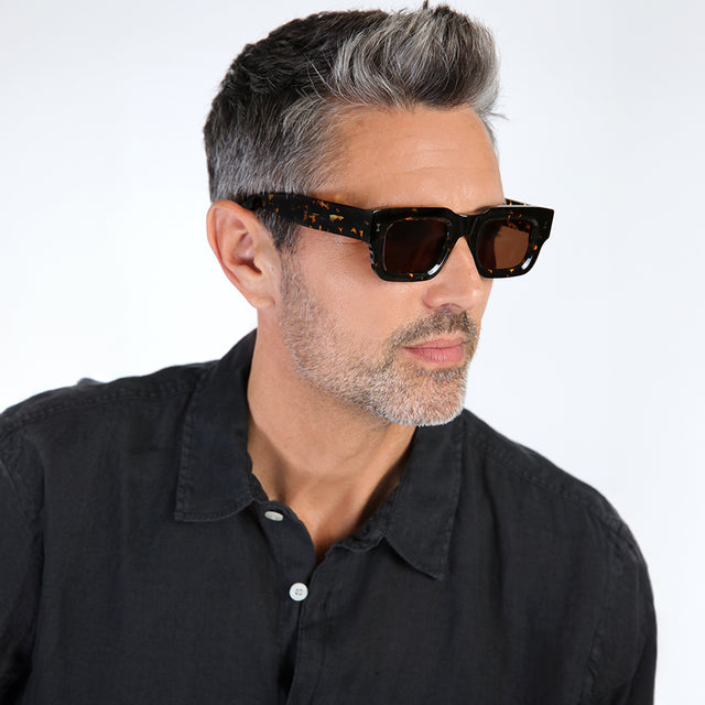 Model with salt and pepper hair and beard wearing Lewis Sunglasses Flame with Brown Flat