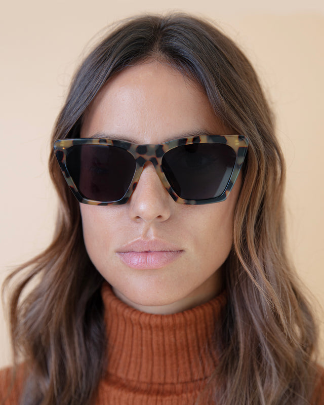 Brunette model with wavy hair wearing Lisbon Sunglasses Tortoise with Grey