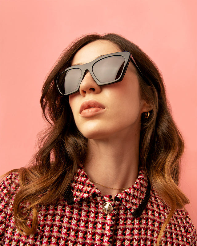 Woman in a tweed jacket wearing the Lisbon Sunglasses in Black