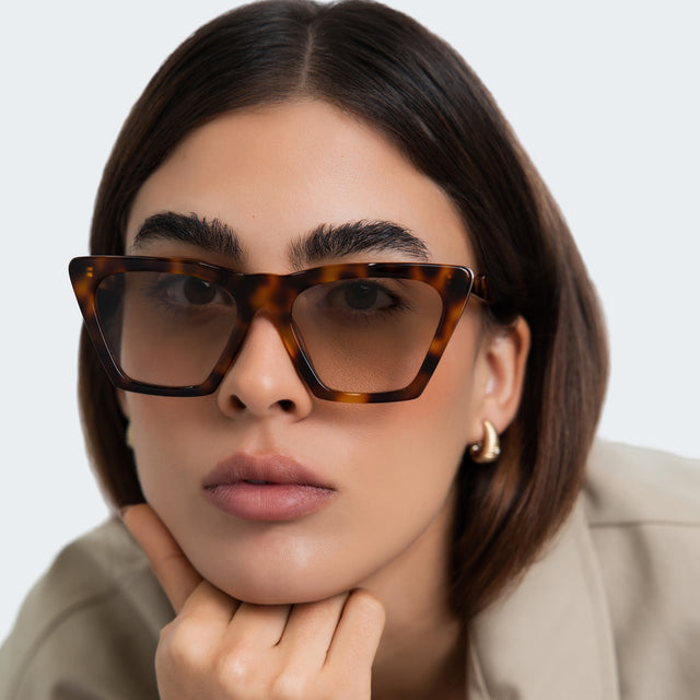 Close up of woman in a trench coat wearing Lisbon Sunglasses Havana with Taupe Gradient