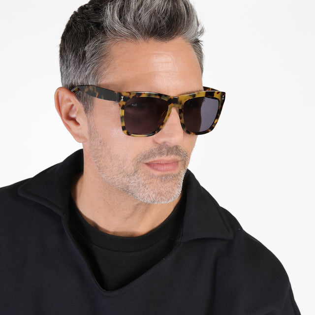 Model with salt and pepper hair and beard wearing Los Feliz Sunglasses Tortoise with Grey