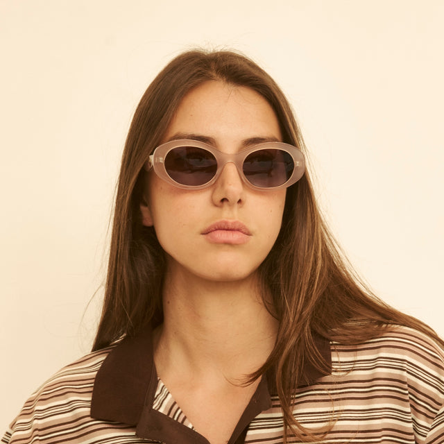 Woman in a striped blouse wearing Luna Sunglasses Thistle with Brown Flat
