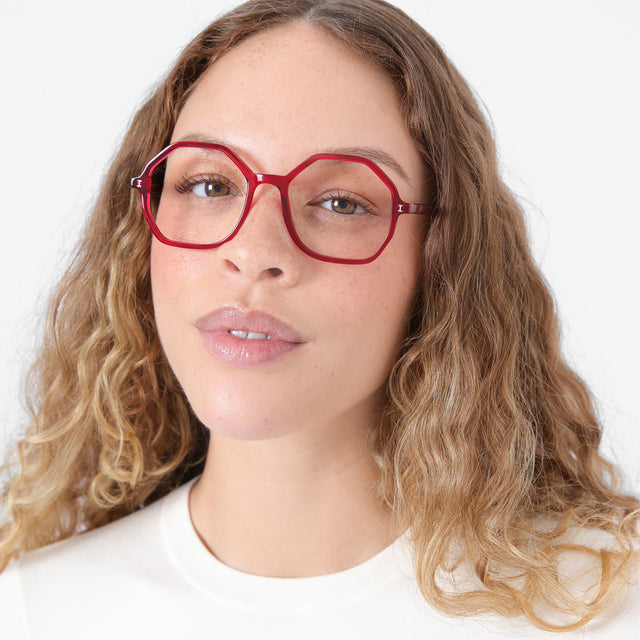 Brunette model with ombré, natural curls wearing Magdalena Optical Mulberry Optical