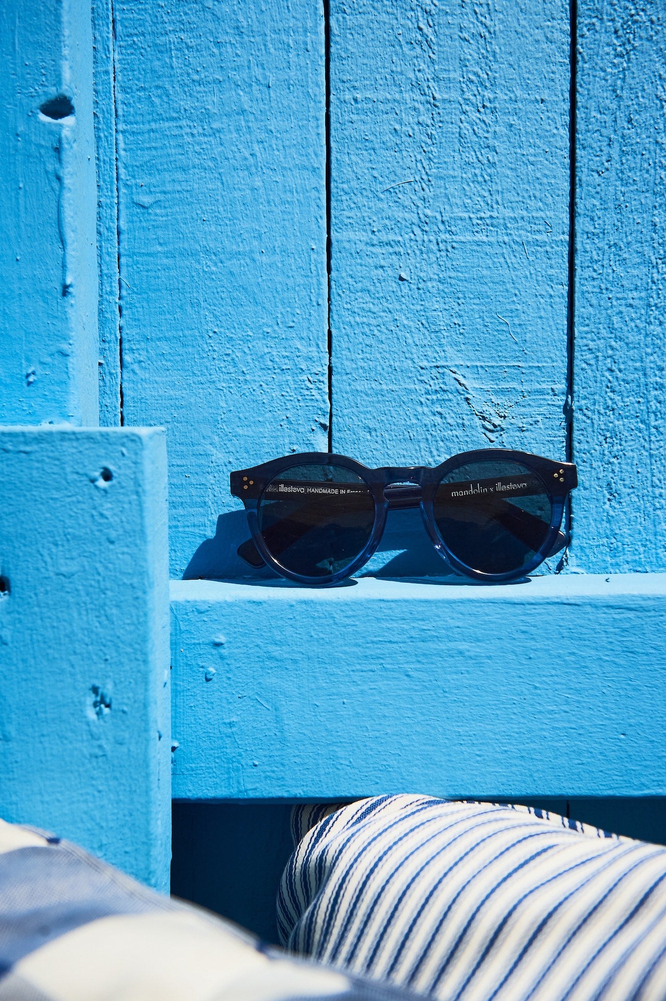 Mandolin collaboration frames against a blue wooden fence