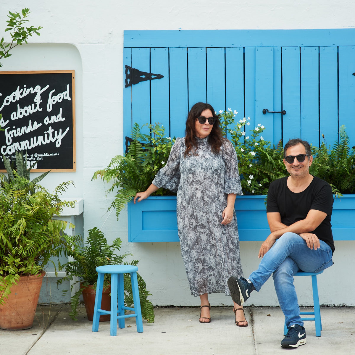 A man and woman in front of the Mandolin boutique