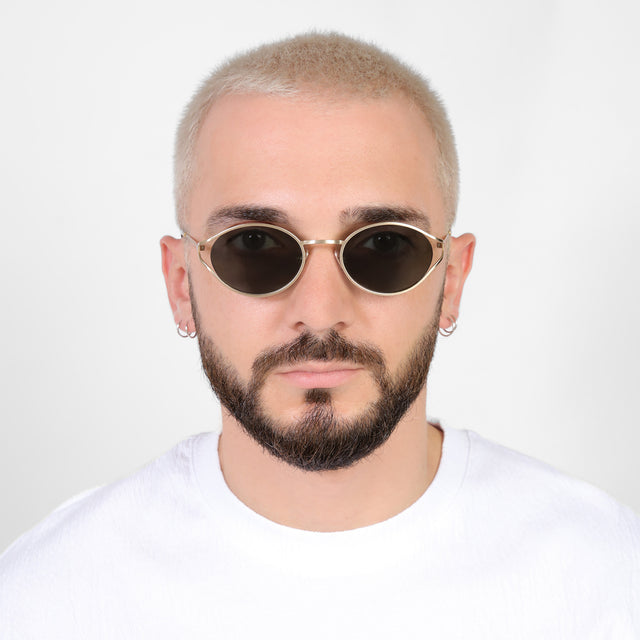 Model with platinum buzzcut wearing Maria Sunglasses Gold with Grey