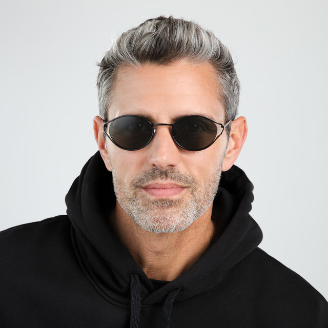 Model with salt and pepper hair and beard wearing Maria Sunglasses Black with Grey