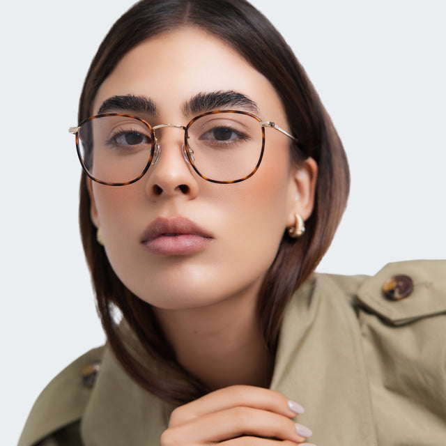 Woman in a trench coat wearing Mayfair Optical Havana/Gold Optical