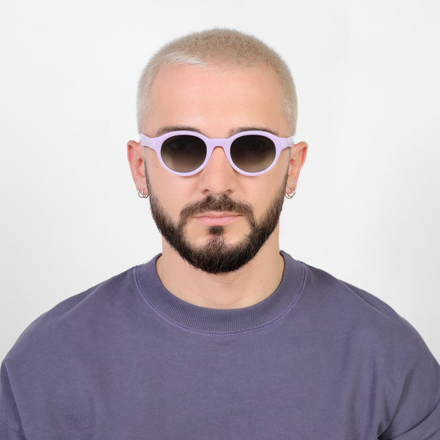 Model with platinum buzzcut wearing Medellin Sunglasses Matte Lilac with Olive Gradient