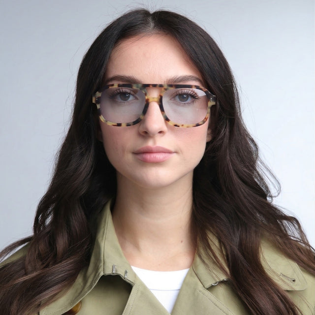 Woman in a trench coat wearing Memphis Sunglasses Tortoise with Light Blue See Through