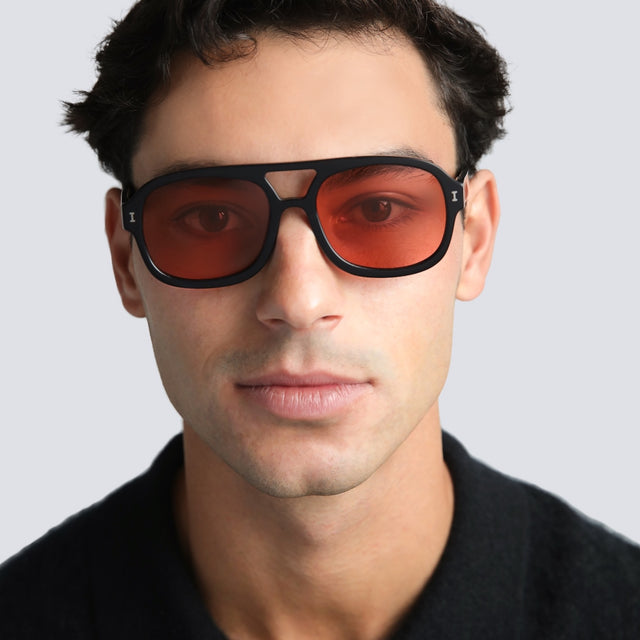Man in a black tee wearing Memphis Sunglasses Black with Sunset