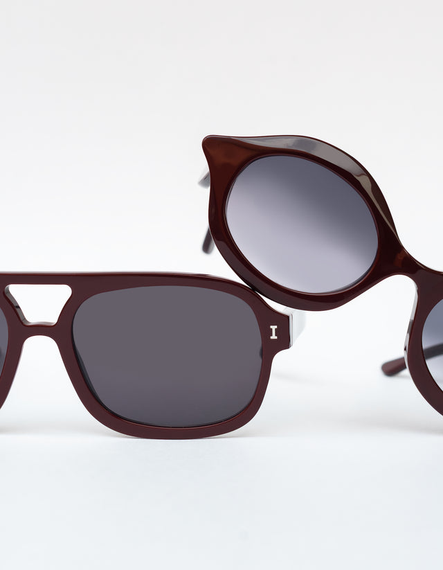 Willow Sunglasses in Bordeaux leaning on Memphis Sunglasses in Bordeaux