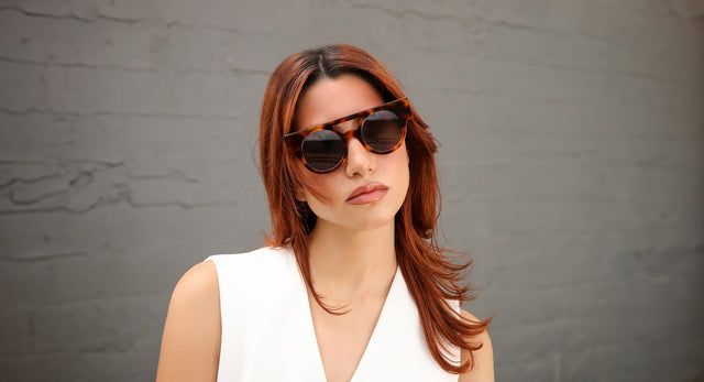 Model with red hair wearing a white vest and the Meyer Sunglasses 15 Year Anniversary Edition in Havana with Grey Flat