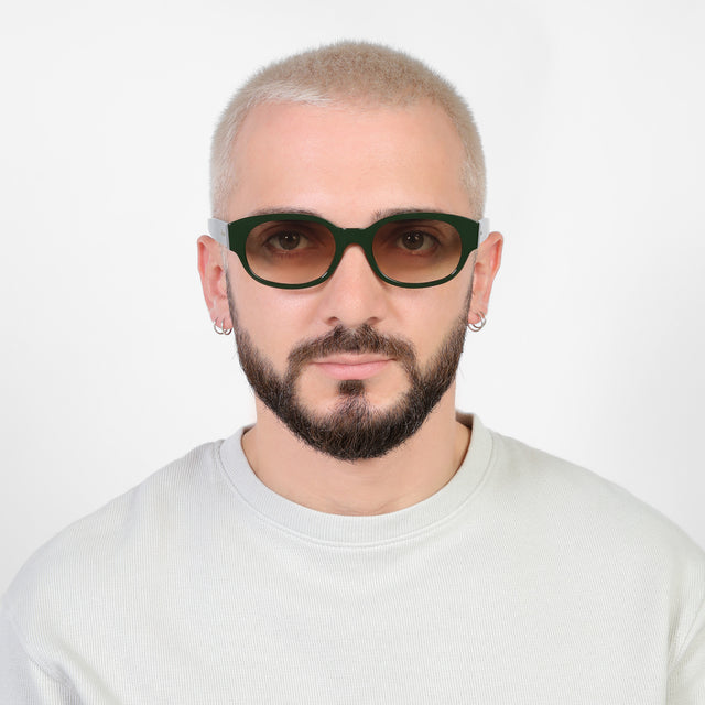 Model with a platinum buzzcut wearing Montreal E Sunglasses Evergreen with Taupe Flat Gradient