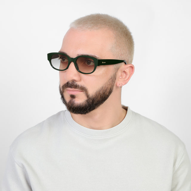 Bearded model looking right wearing Montreal E Sunglasses Evergreen with Taupe Flat Gradient