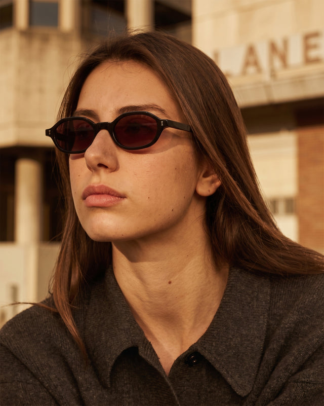 Woman in Paris wearing the Munich Sunglasses in Black with Plum lenses