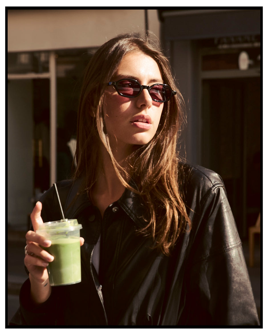 Woman wearing the Munich Sunglasses in Black with Plum See Through