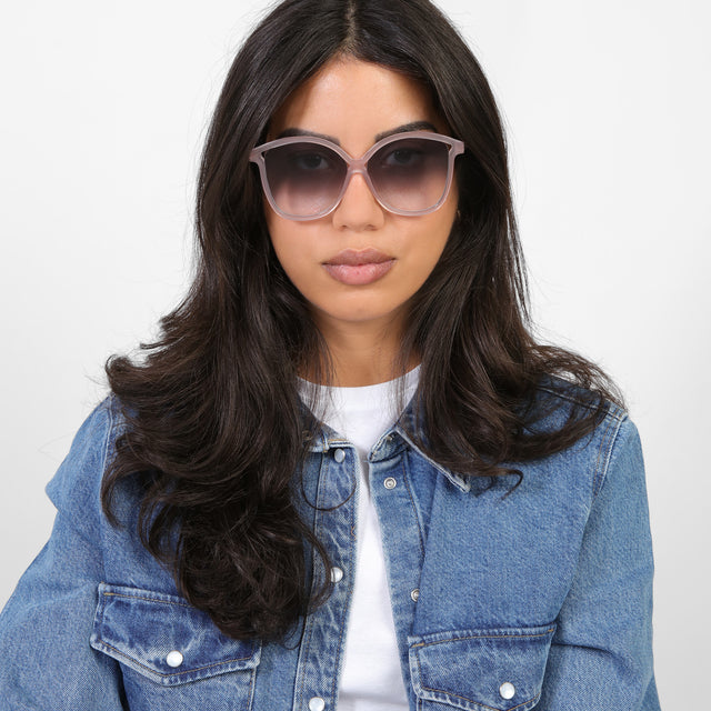 Brunette model in a denim jacket wearing Nancy 57 Sunglasses Thistle with Grey Gradient