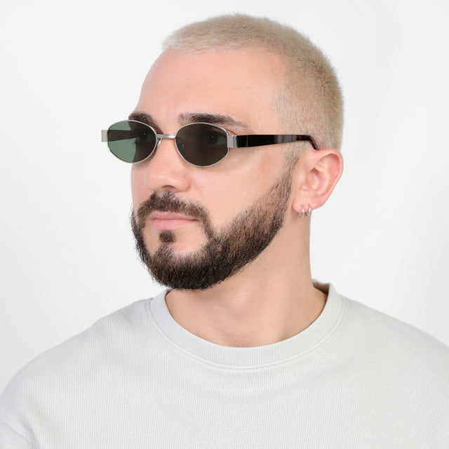 Bearded model looking right wearing Nesso Sunglasses Silver with Olive