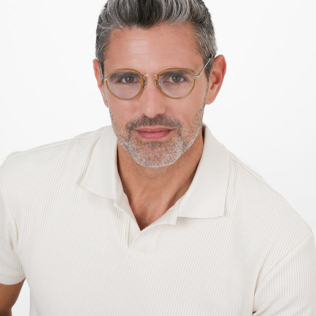 Model with salt and pepper hair wearing Oxford Optical Oak/Silver Optical