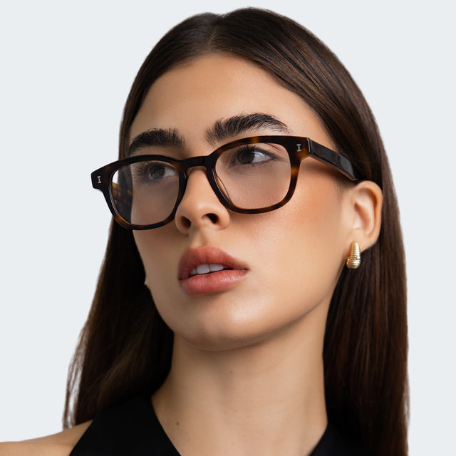 Woman in a black blouse wearing Pacific Optical Havana Optical
