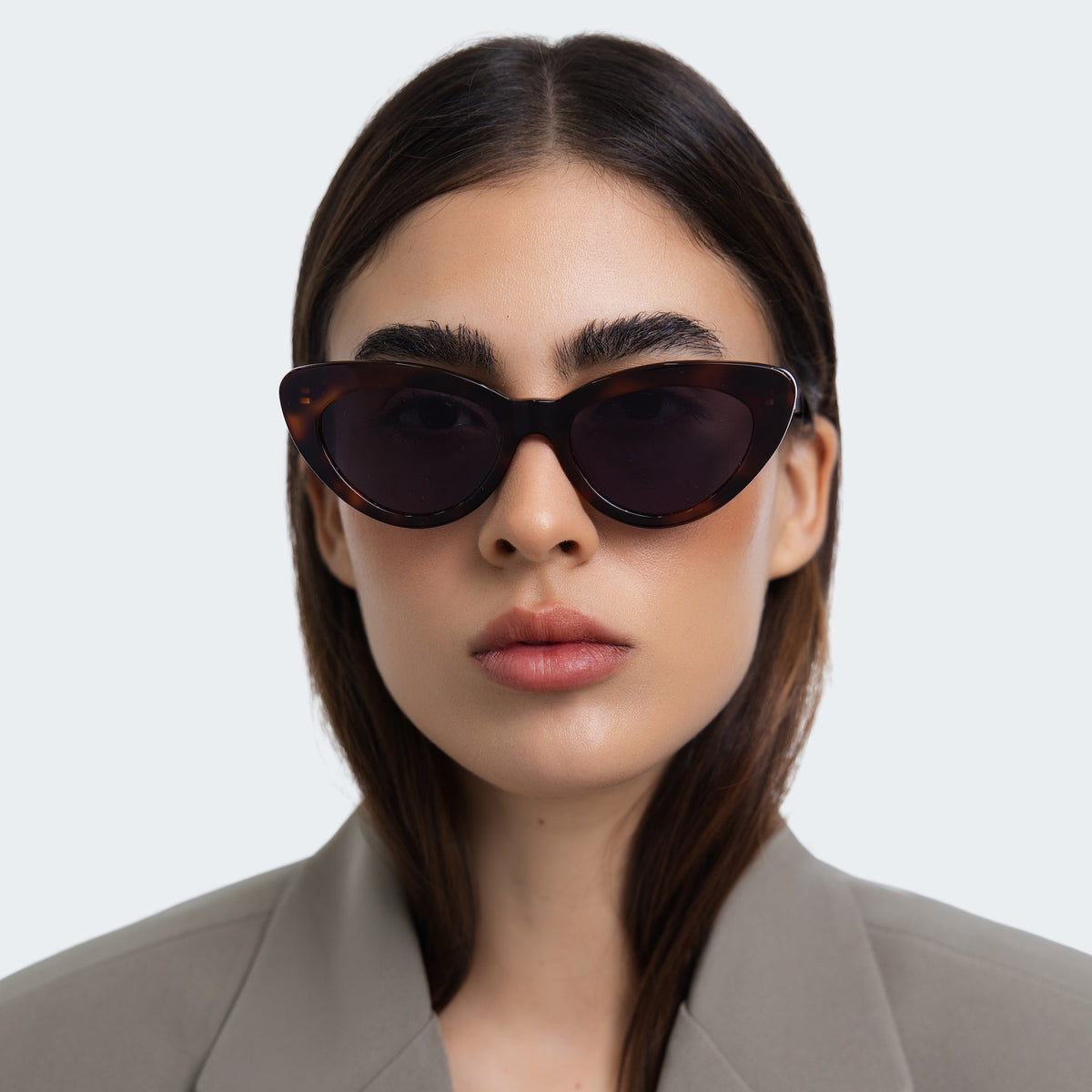 Woman wearing Pamela Sunglasses in Havana with Grey Flat lenses, front view, Woman in a grey blazer