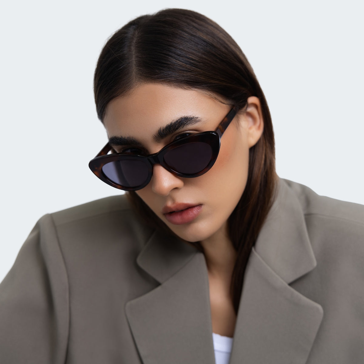 Woman wearing Pamela Sunglasses in Havana with Grey Flat lenses, side profile, Another angle of a woman in a grey blazer